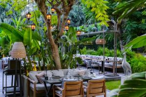 a restaurant with tables and chairs in a garden at Barut Hemera - Ultra All Inclusive in Side