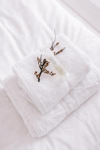 a white towel with a tree on top of it at Hlid Bed and Breakfast in Myvatn