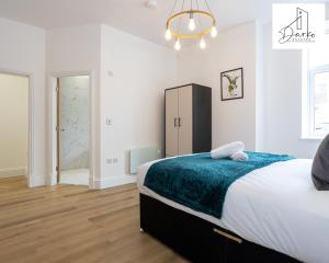 a bedroom with a large bed with a blue blanket at Apartment 1 - Beautiful 1 Bedroom Apartment Near Manchester in Worsley