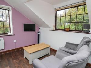 a living room with a couch and a tv at Tancoed in Aberystwyth