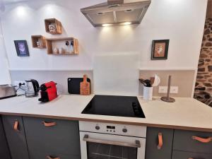 a kitchen with a counter top with a sink at LA FERMETTE - Wifi - Parking - Netflix - Disney+ in Saint-Jorioz