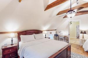a bedroom with a large bed and a ceiling fan at Cozy Modern Farmhouse in Wallingford