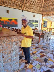 a man standing in front of a stone counter at Mimi na wewe villa in Nungwi +61 photos