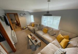 a living room with a couch and a table at Westend Holiday Let 3 Brecon in Brecon