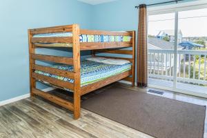 a bunk bed on the balcony of a house at CB45 2B at the Beach in Carolina Beach +22 photos