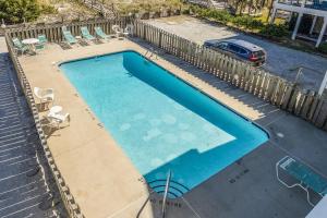 an overhead view of a swimming pool with chairs and a car at CB45 2B at the Beach in Carolina Beach