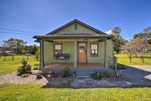 a green tiny house with a wooden porch at Updated Brevard Home - Close to Downtown! in Brevard
