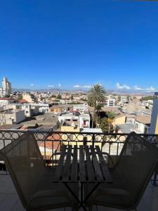 a bench on a balcony with a view of the city at Nicosia City Centre Sky Views Apartment in Nicosia