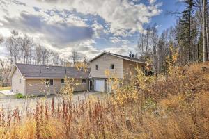 a house sitting in the middle of a field at Convenient Fairbanks Guest Suite with Grill! in Fairbanks