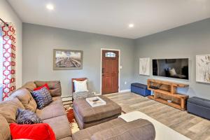 a living room with a couch and a tv at Convenient Fairbanks Guest Suite with Grill! in Fairbanks