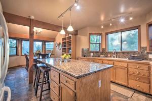 a kitchen with a large island with a counter top at Deck + Grill: Mtn Haven in Stanislaus Nat'l Forest in Arnold