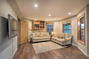 a living room with two couches and a flat screen tv at Deck + Grill: Mtn Haven in Stanislaus Nat'l Forest in Arnold