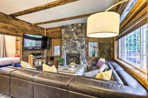 a large leather couch in a living room with a stone wall at Tahoe City Getaway about 1 Mi to Commons Beach! in Tahoe City
