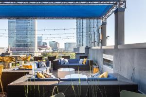 a rooftop patio with couches and a view of a city at Locale Lofts The Gulch - Nashville in Nashville