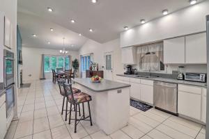 a large kitchen with white cabinets and bar stools at Unique Pet-Friendly Dover Home with Skylight in Dover