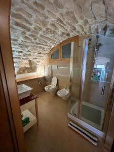 a bathroom with a shower and a sink and a toilet at Admirari in Tropea +8 photos