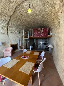 a dining room with a wooden table and chairs at Admirari in Tropea