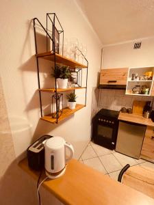 a kitchen with a table with a coffee mug on it at Apartamenty KTW Park Śląski Luksusowy PRL in Katowice