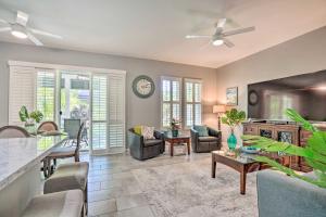 a living room filled with furniture and a clock at Coastal Ko Olina Townhome - Walk to Beaches! in Kapolei
