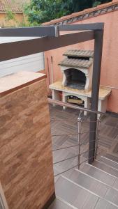 a grill sitting on a patio with a fence at Maison MICDEN in Saint-Jean-Pla-de-Corts +13 photos