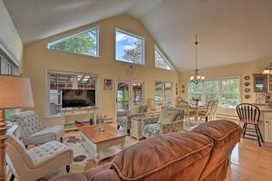 a living room with a couch and a table at Inviting Lakefront Home Seasonal Boat Dock! in Dedham