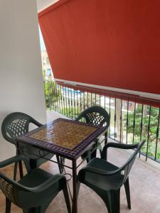 a patio table and chairs on a balcony at El SOL del SUR in La Herradura