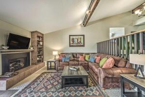 a living room with a couch and a fireplace at Villa Con Vista with Putting Green and Hot Tub! in Ruidoso