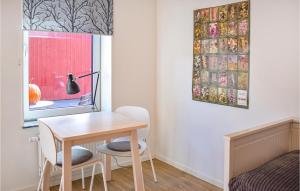 a room with a table and two chairs and a window at Cozy Apartment In Frjestaden With Wifi in Färjestaden