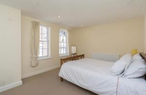 a bedroom with a white bed and two windows at The Georgian House in Liverpool City Centre in Liverpool