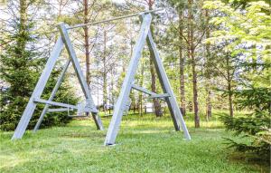 a metal swing set in the grass in a park at One-Bedroom Holiday Home In Biskupiec in Biskupiec