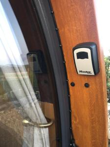 a door with a toaster on it next to a window at Hilltop Hideaway - Secluded pod with private hot tub in Newry