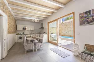 a kitchen and dining room with a table and chairs at House Can Diana in Campanet