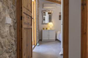 a hallway with a room with a mirror and a sink at House Can Diana in Campanet +27 photos