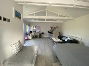 a living room with a bed and a couch at Stonebury Lodge in Coventry