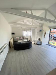 a large living room with a black leather couch in the middle at Stonebury Lodge in Coventry