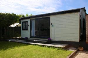 a mobile home with a large sliding glass door at Stonebury Lodge in Coventry