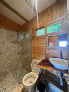 a bathroom with a toilet and a sink and a shower at Luxury Tiny House - Minca in Minca