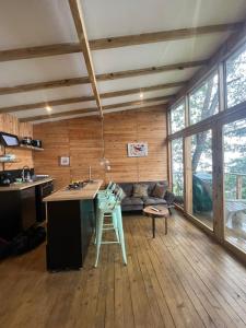 a kitchen and living room with a couch and a table at Luxury Tiny House - Minca in Minca