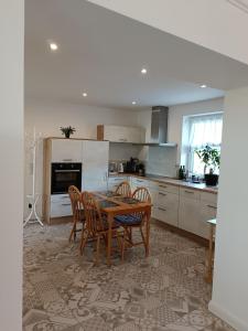 a kitchen with a wooden table and chairs at Ferienwohnung zum Wohlfühlen in Lengerich +30 photos