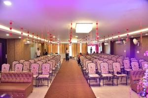 a row of chairs in a room with people in it at The Arcas Hotel in Lucknow