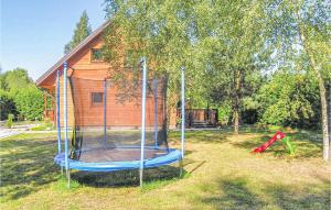 a playground in a yard next to a house at Awesome Home In Pisz With Outdoor Swimming Pool in Pisz