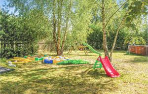 a park with a playground with a tree and a slide at Awesome Home In Pisz With Outdoor Swimming Pool in Pisz