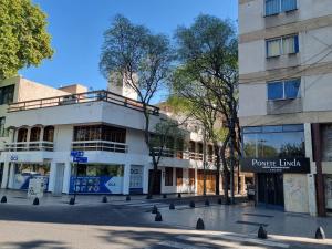 a building on a street next to a building at Cėntrico PARQUE CÍVICO in Mendoza