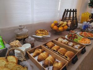 a table filled with different types of bread and fruit at Garda Room in Peschiera del Garda