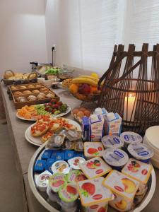 a table topped with lots of food and plates of food at Garda Room in Peschiera del Garda