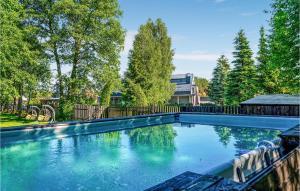 a swimming pool in a yard with trees at Gorgeous Apartment In Nidzica With Sauna in Nidzica