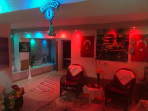 a room with chairs and a clock on the wall at Astoria Beach Hotel in Marmaris