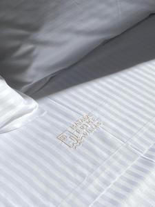 a white bed with a white comforter with the word sleep on it at Matala Prime Villas in Matala