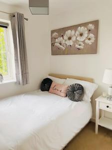 a bed with two pillows on it in a bedroom at Cathedral Apartment in Lichfield