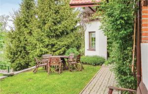 a table and chairs in the yard of a house at Gorgeous Home In Lidzbark Warminski With House Sea View in Lidzbark Warmiński